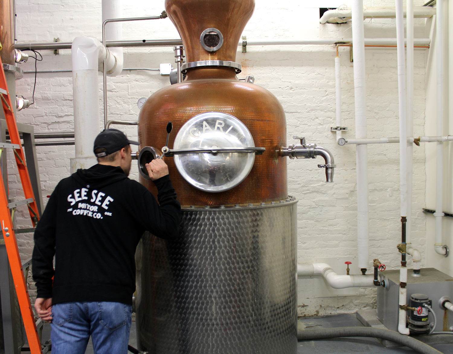 Ryan Montgomery looking into the copper still
